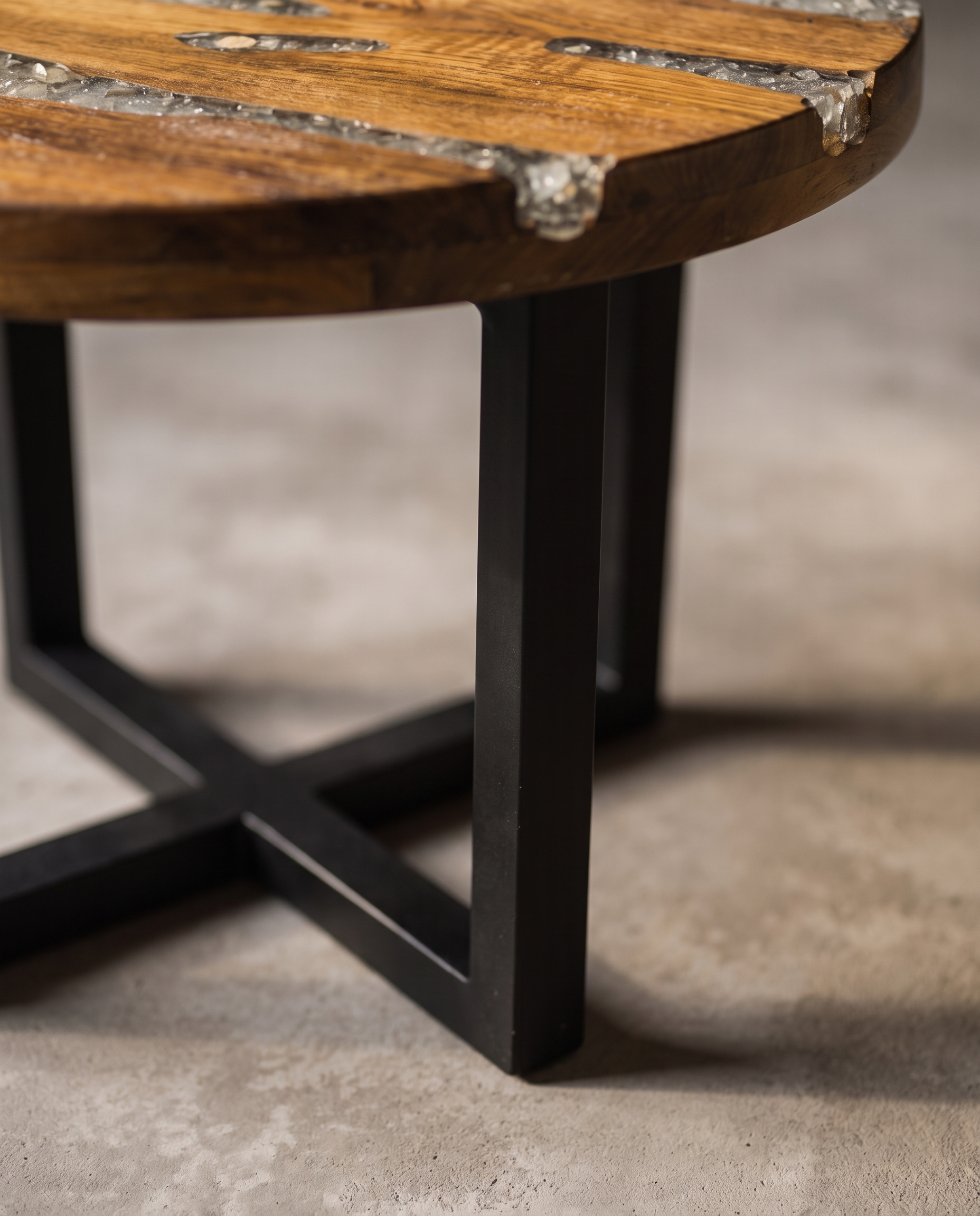 Close-up of the Creeklight Parlor Table matte black steel X-frame base