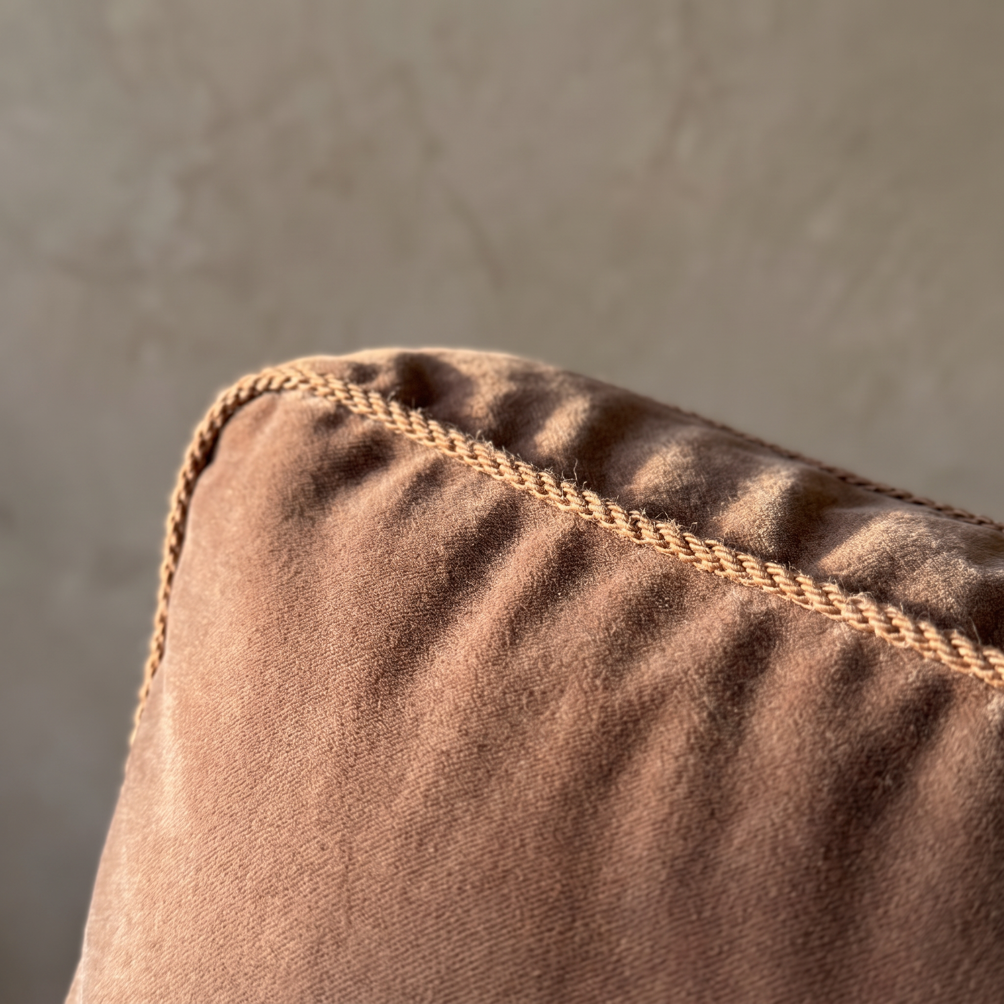 Macro detail of the velvet nap and twisted cord welt trim on the Taylor King sofa