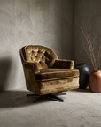 Olive velvet vintage rocking chair, lifestyle hero, greige plaster room with stoneware vessels and dried branches