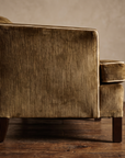 Detail of the sofa arm, ivory welt piping, and tapered wood leg