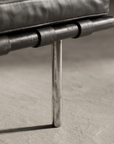 Second detail of the Barcelona Daybed's round chrome leg and floor contact point