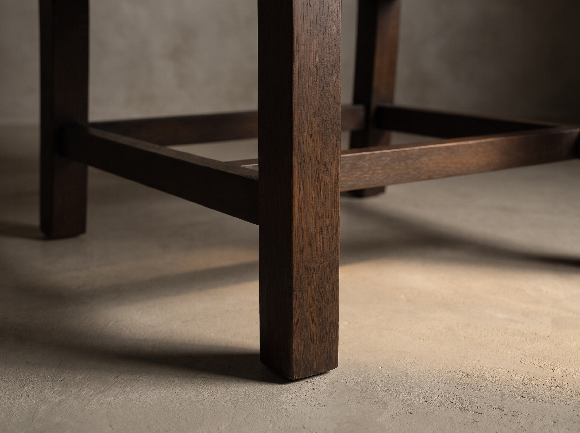 Macro detail of the square espresso wood leg and stretcher base