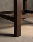 Macro detail of the square espresso wood leg and stretcher base