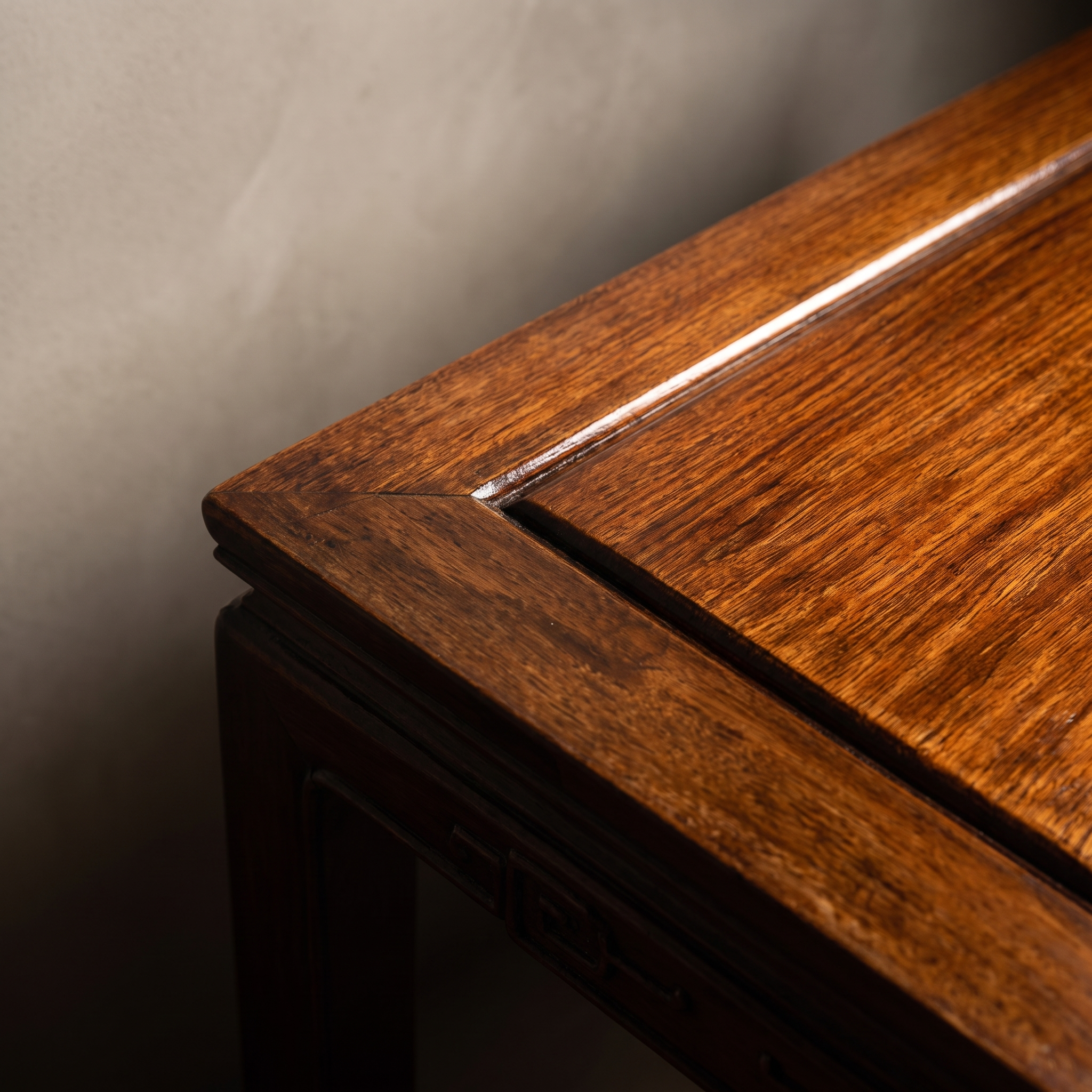 Macro detail of the tabletop wood grain and molded frame corner
