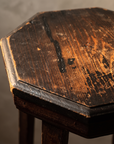 Close up detail of the worn painted top surface showing wood grain beneath the chipped paint