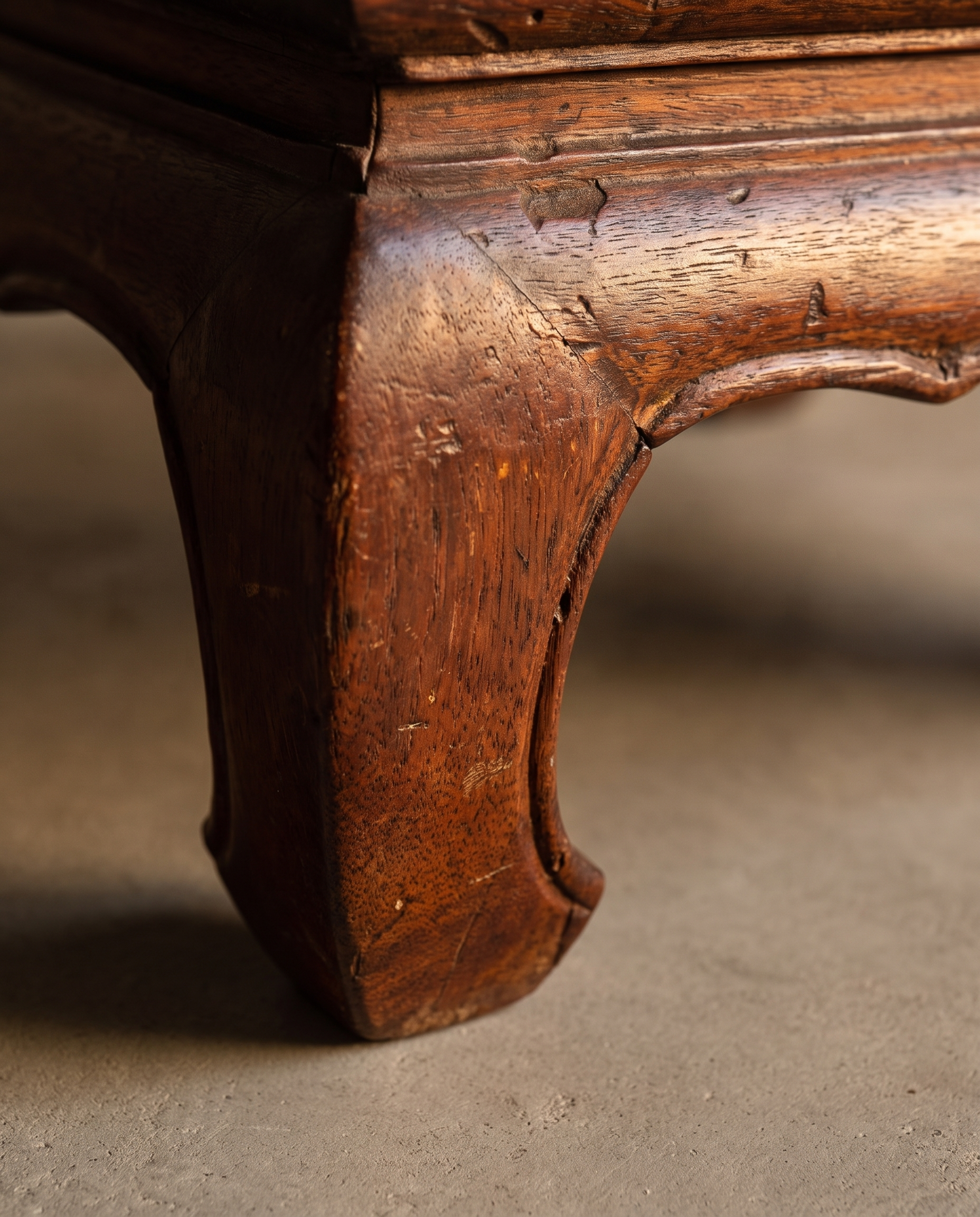 Close-up of the Medium Kang Table's horsehoof leg, apron, and arched cutout