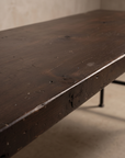 Close-up detail of the reclaimed wood tabletop grain, knots, and edge