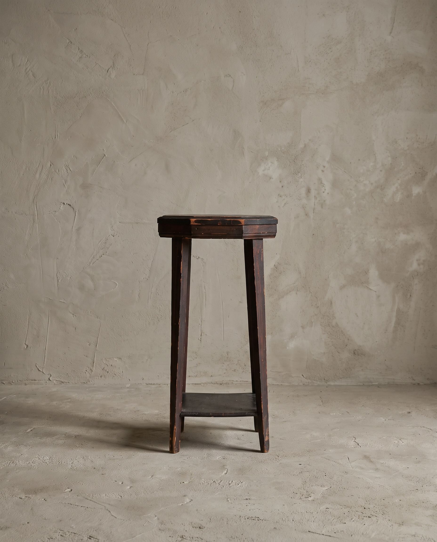 Straight-on front view of the rustic accent stool showing its full silhouette against a plaster wall