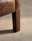 Macro detail of the tapered wood leg and base construction