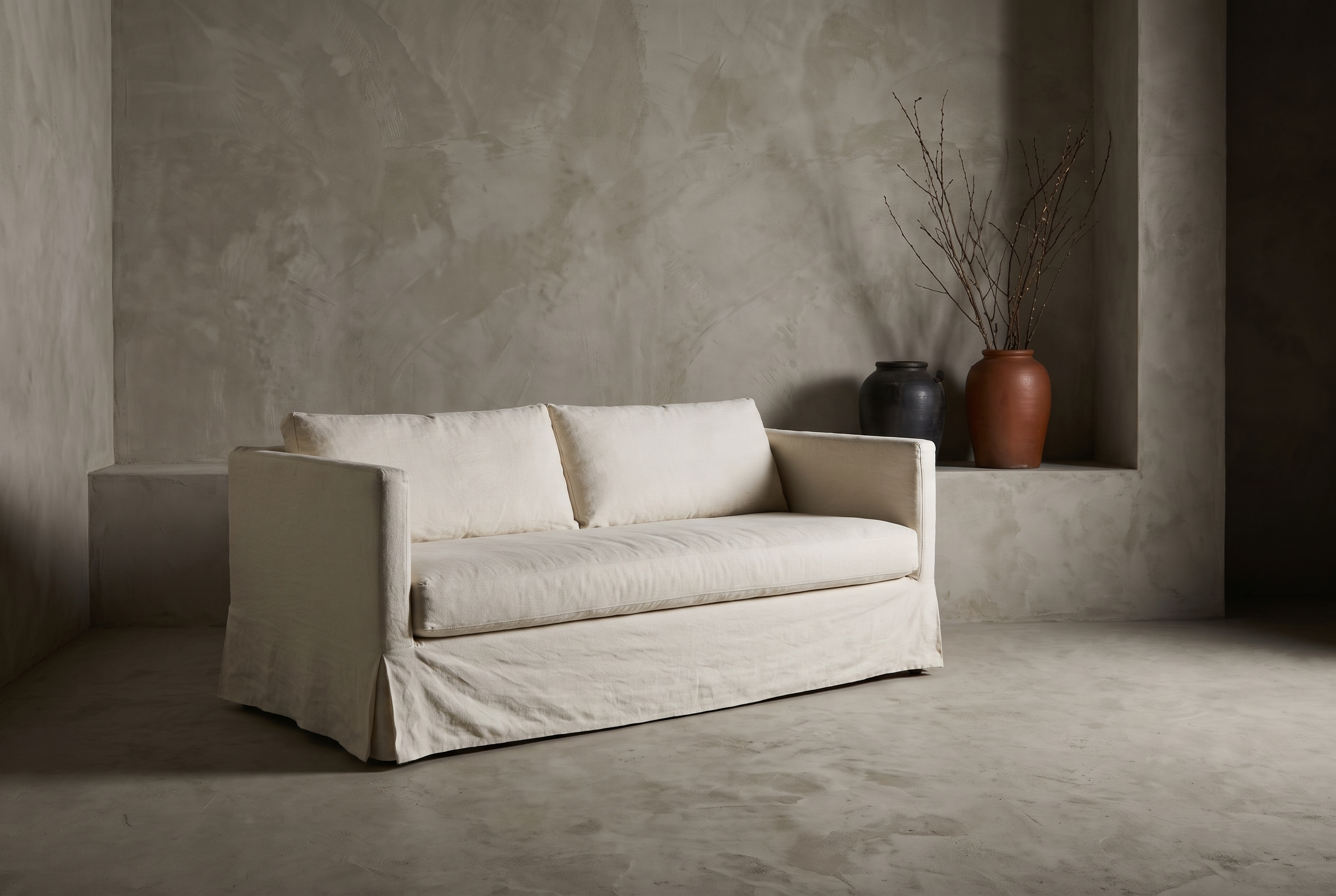 Restoration Hardware linen track-arm sofa styled in a greige plaster room