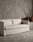 Restoration Hardware linen track-arm sofa styled in a greige plaster room