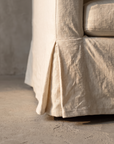 Detail of the kick-pleat linen skirt corner on the sofa