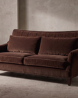 Taylor King espresso brown velvet sofa, close low-angle view showing full form and construction