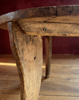 Antique round coffee table, darker, leg and corner brace detail