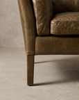 Macro detail of the leather-wrapped tapered leg, lightly worn