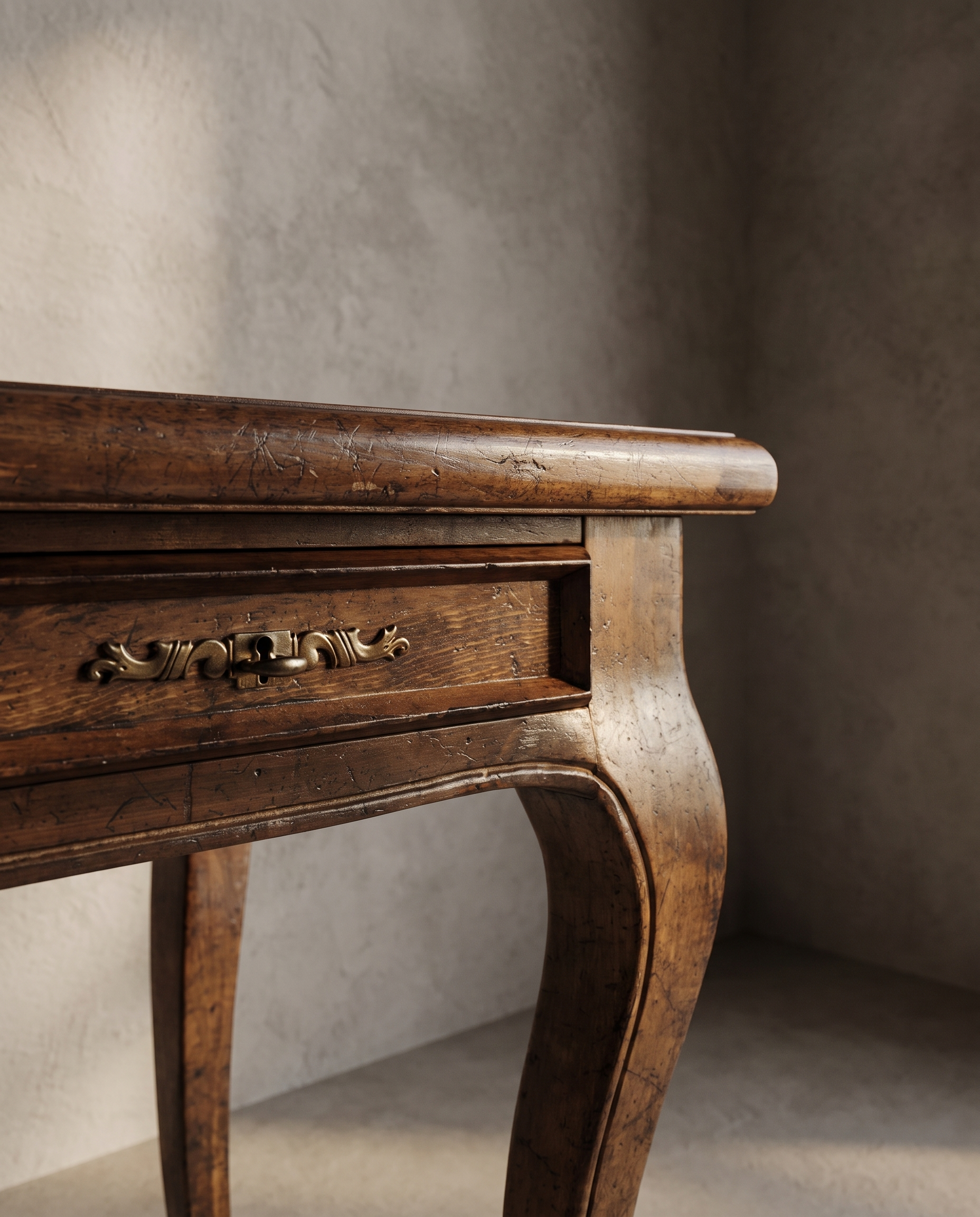 The Cabriole Writing Desk, macro detail of the side drawer corner and brass pull