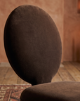 Detail of the oval velvet back and seat junction, alternate angle, warm domestic room
