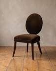 Mitchell Gold + Bob Williams oval-back dining chair in espresso brown velvet, three-quarter view