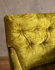Macro detail of the diamond button-tufted back on the chartreuse velvet armchair