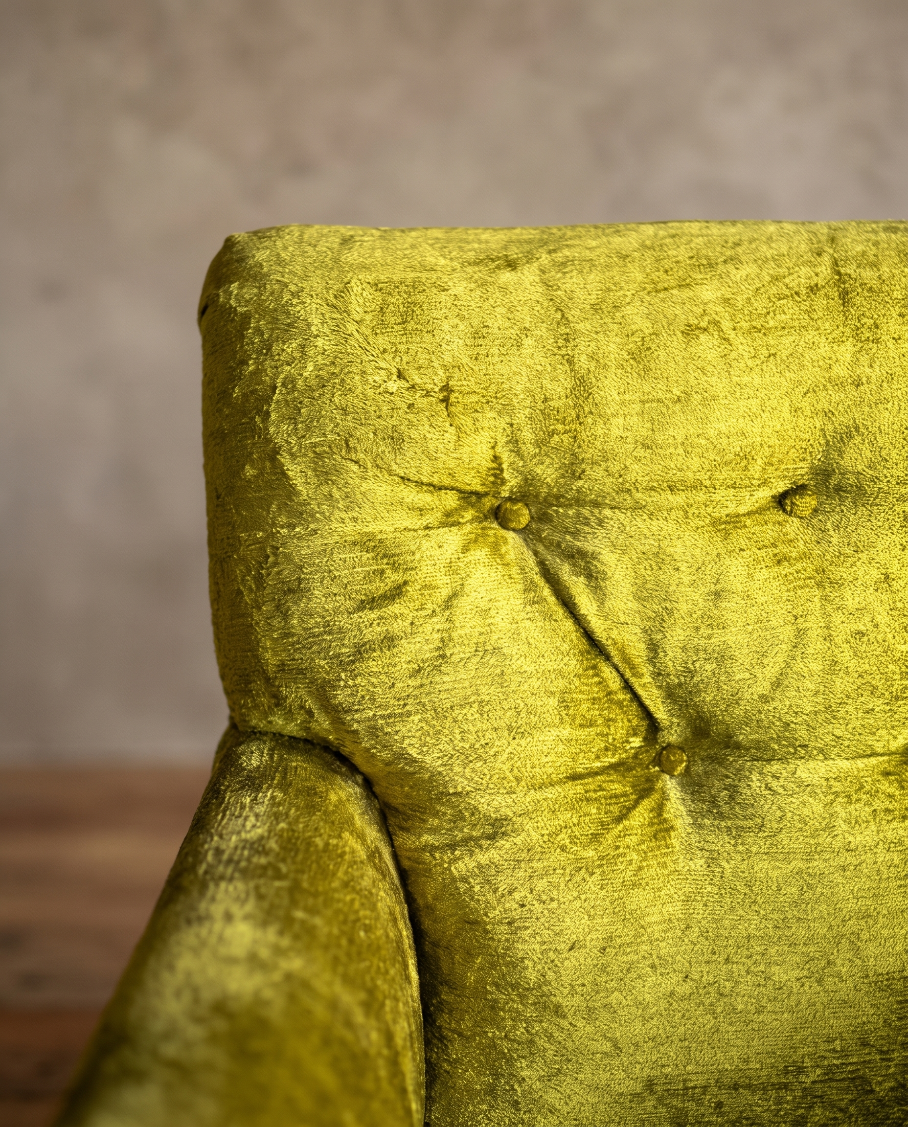 Macro detail of the diamond button-tufted back on the chartreuse velvet armchair, alternate angle