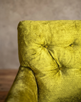 Macro detail of the diamond button-tufted back on the chartreuse velvet armchair, alternate angle