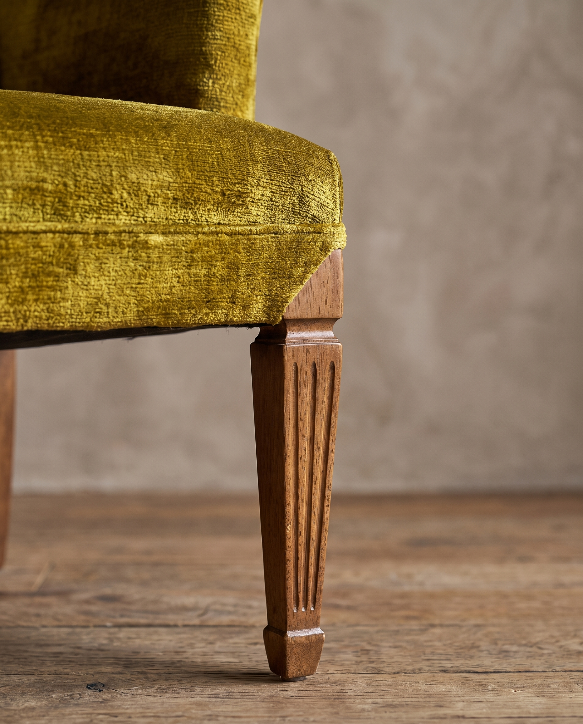 Macro detail of the square track arm and fluted tapered leg on the chartreuse velvet armchair, alternate angle