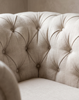 Close detail of the diamond button tufting and the slubby natural flax linen weave
