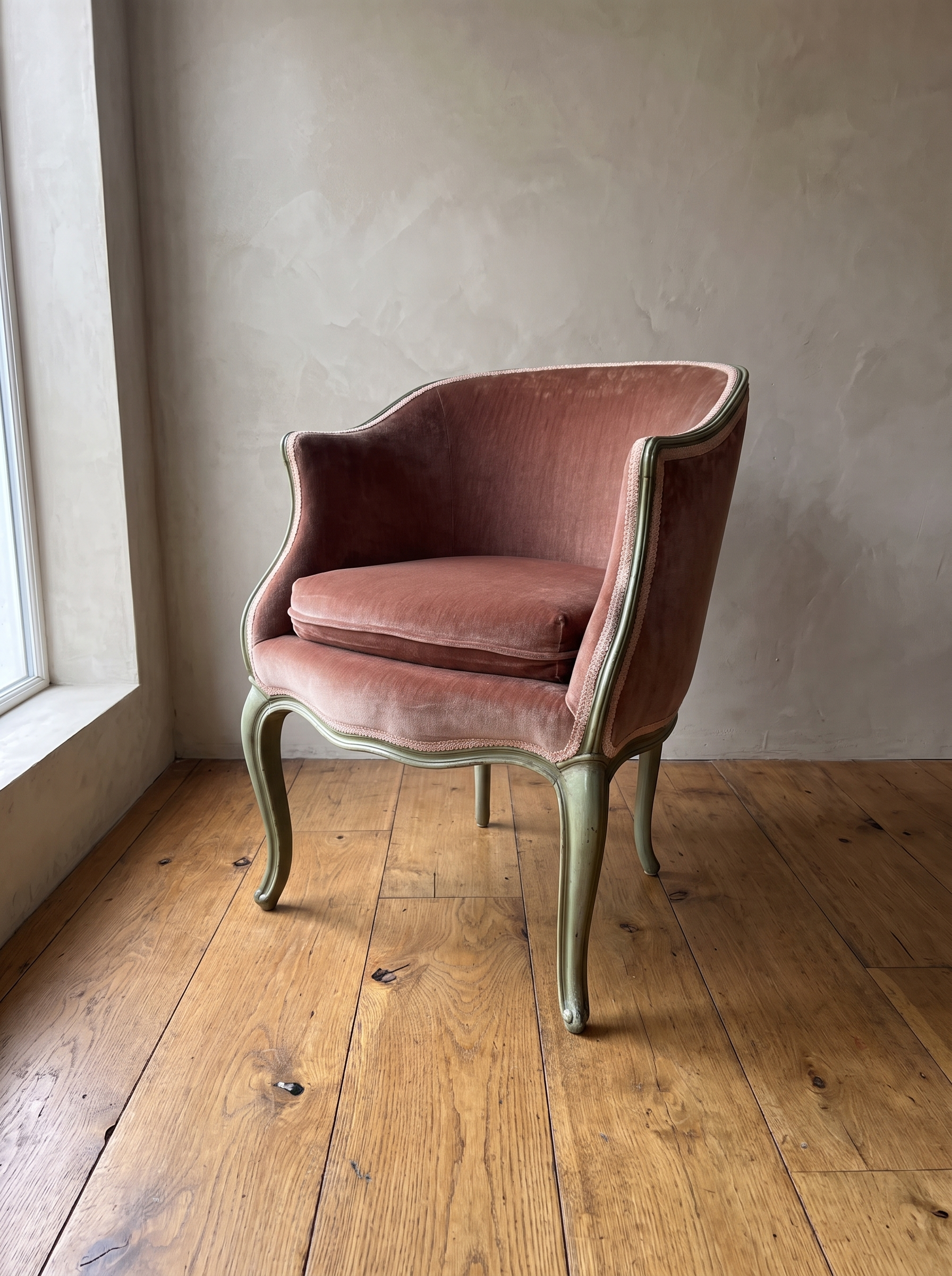 Vintage Louis XV style bergère en gondole in dusty rose velvet with painted sage green frame, front three-quarter view against a plaster wall