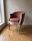 Vintage Louis XV style bergère en gondole in dusty rose velvet with painted sage green frame, front three-quarter view against a plaster wall