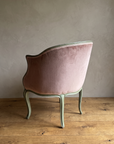 Back view of the rose velvet bergère showing the rounded tub back