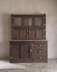 Antique Hoosier Bakers Cabinet front view on a limestone counter against a greige plaster wall