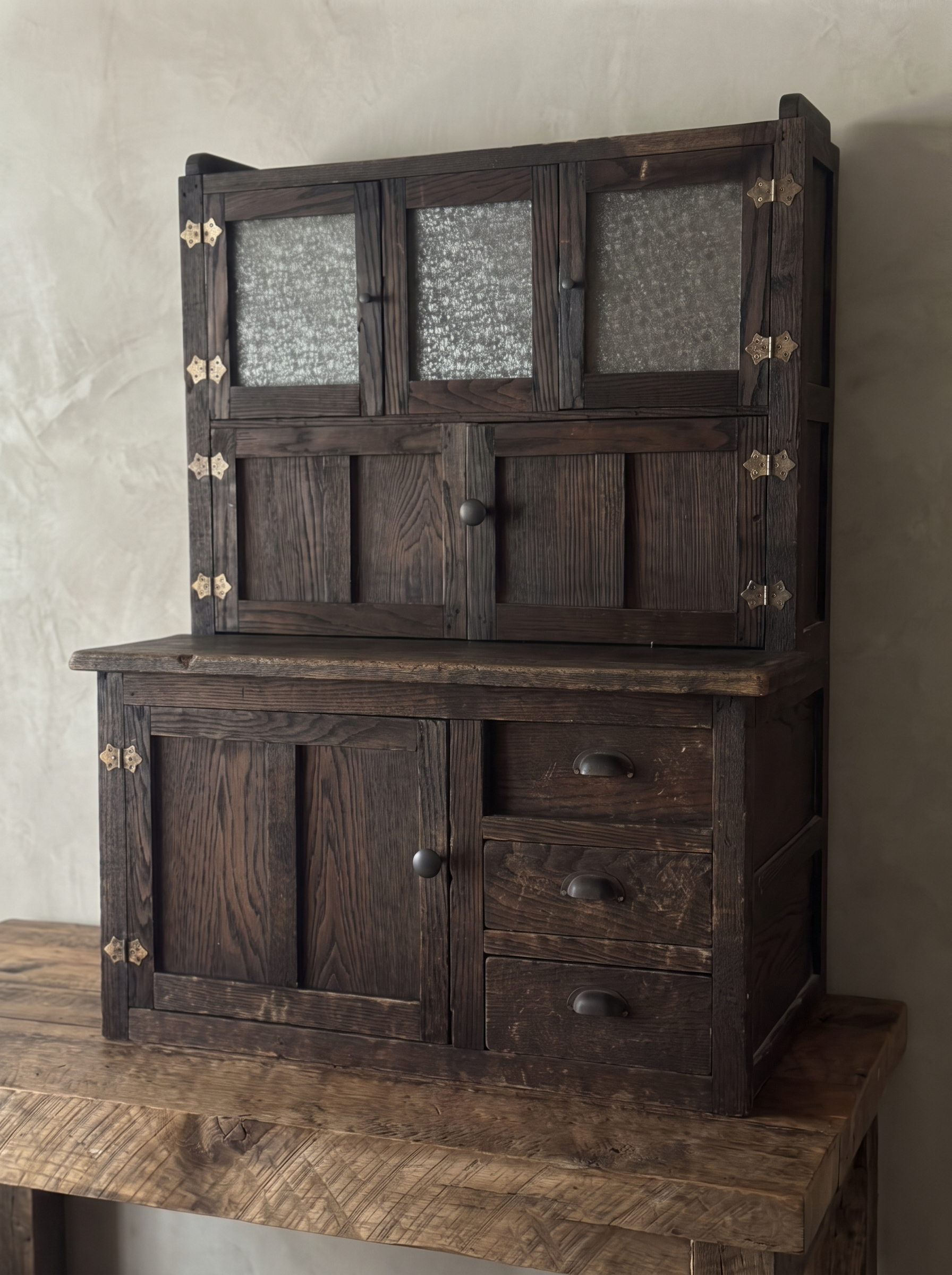 Antique Hoosier Bakers Cabinet three-quarter view from the left on a reclaimed wood table