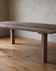 California Redwood Dining Table in fallen old-growth redwood, three-quarter view in a plaster-walled room with reclaimed wood floors