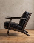 Side profile of the Ember lounge chair showing its recline and splayed back legs