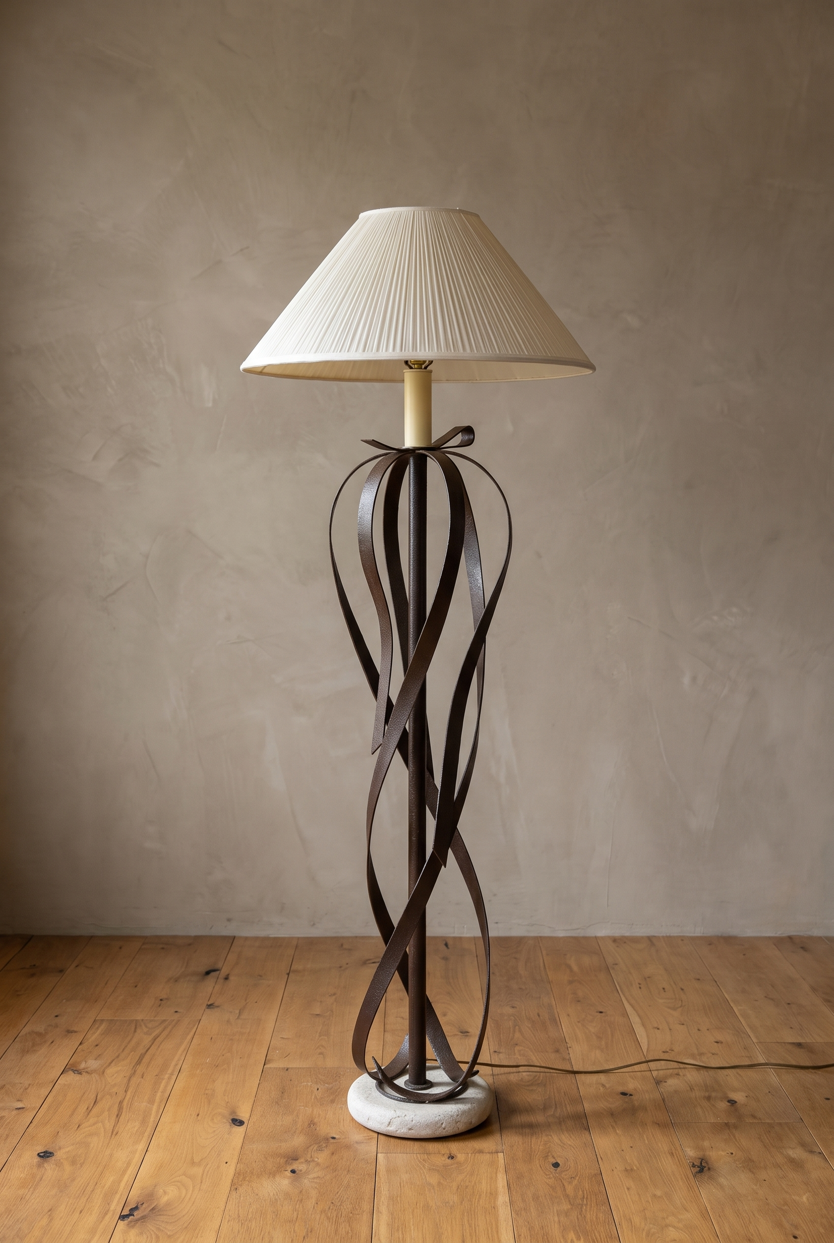 Full view of the ribbon floor lamp, unlit, with travertine base