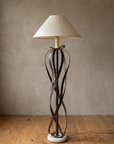 Full view of the ribbon floor lamp, unlit, with travertine base