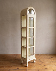 Three-quarter view of the arched glass cabinet showing its glazed side panels and cabriole legs