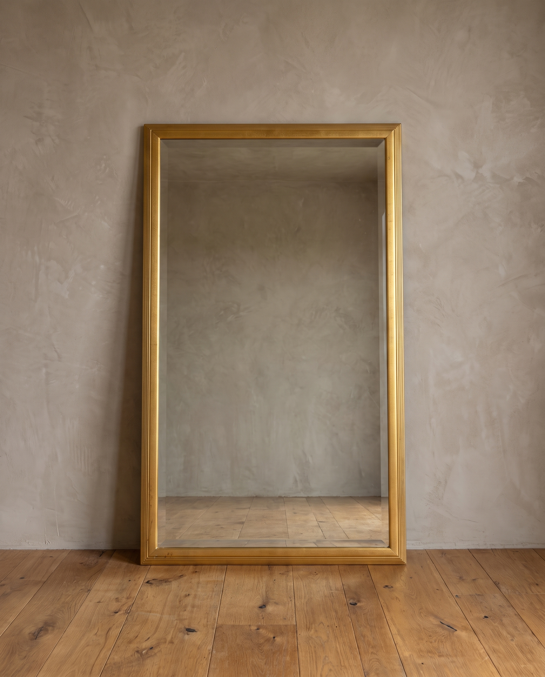 Front view of the gilt reeded mirror with beveled glass