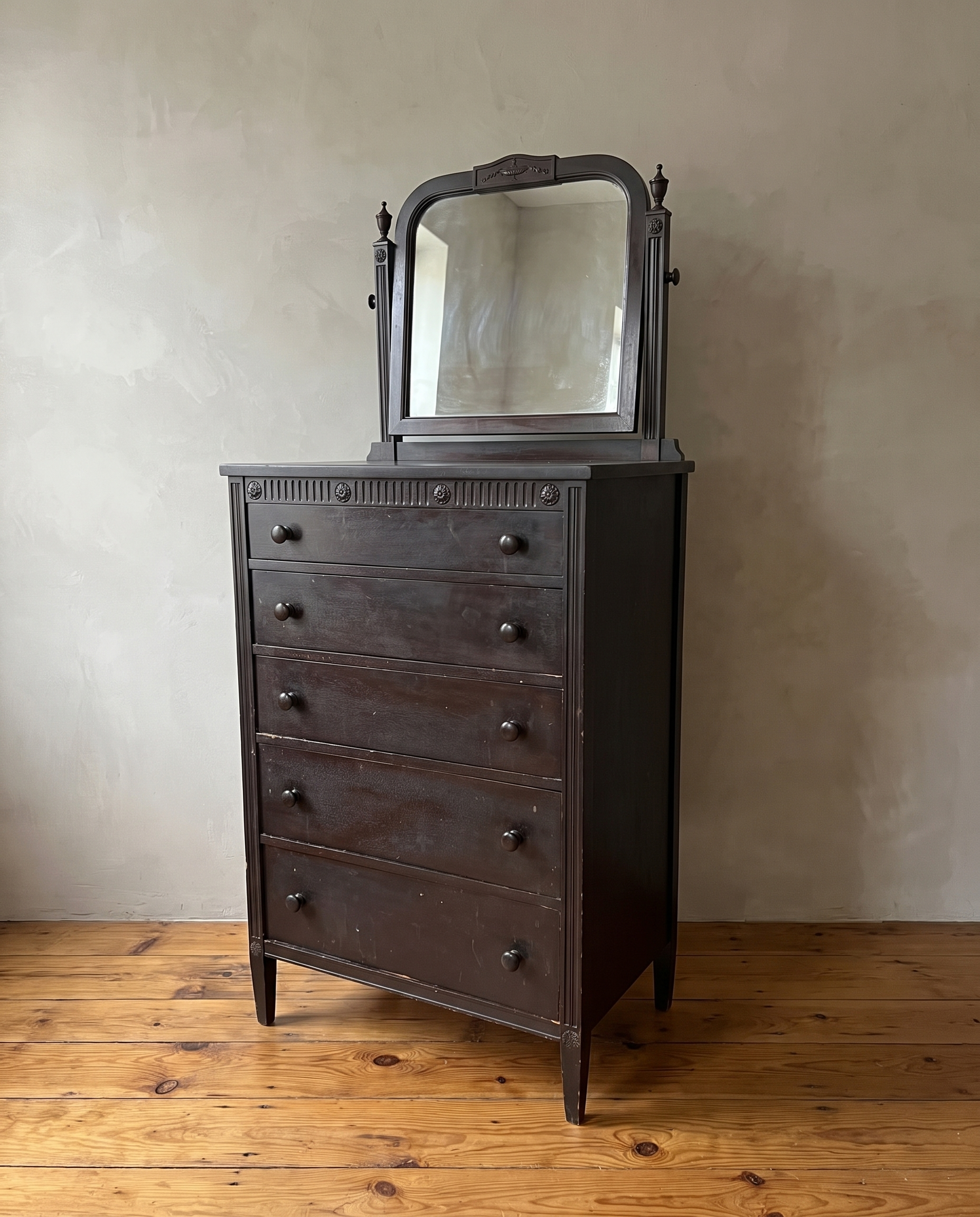 Three-quarter view of the antique chest showing its side, fluted columns and tapered legs
