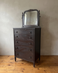 Three-quarter view of the antique chest showing its side, fluted columns and tapered legs
