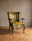 Three-quarter view of the velvet armchair showing the fan channel back, open wood arms and cabriole legs