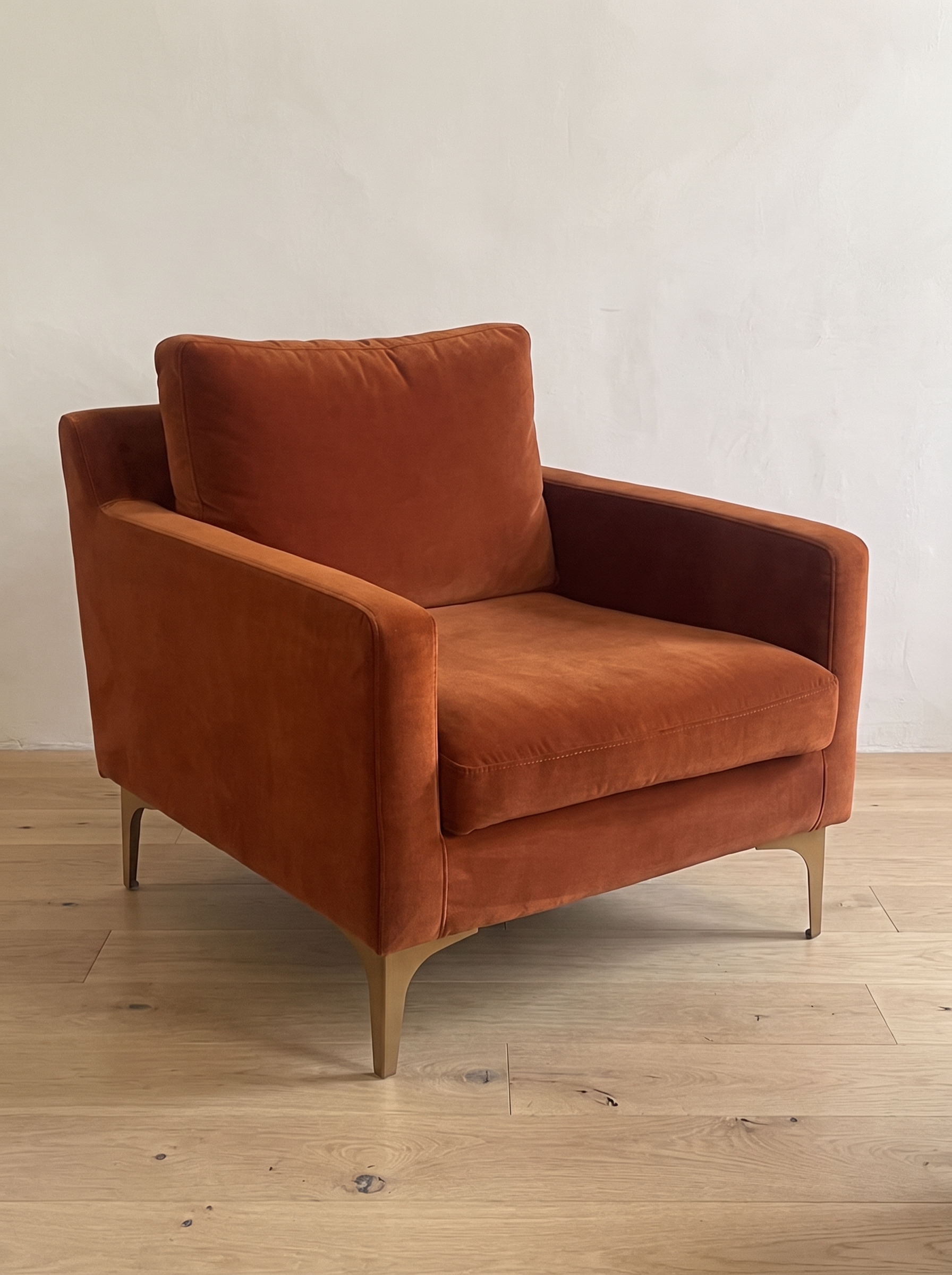 Rust velvet armchair, three-quarter view from the left