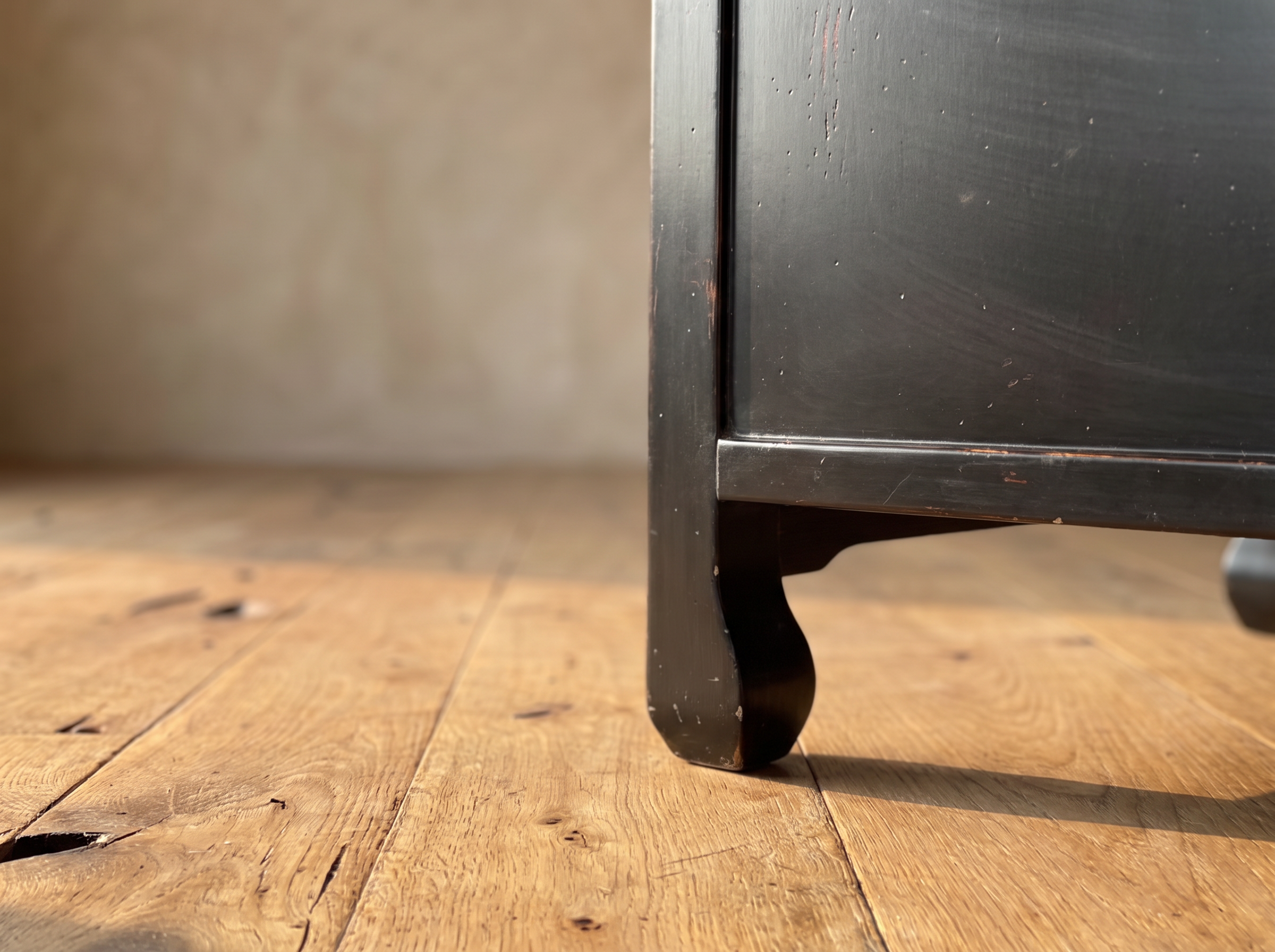 Close-up of the curled hoof foot on a reclaimed wood floor