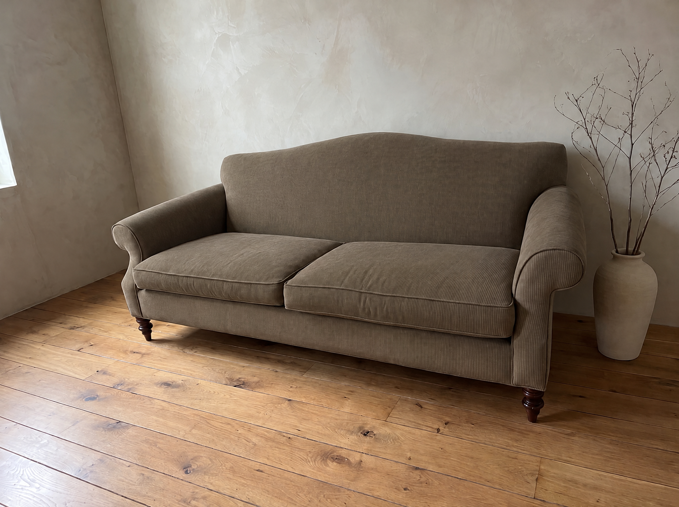 The Marcel camelback sofa, three-quarter view from the left