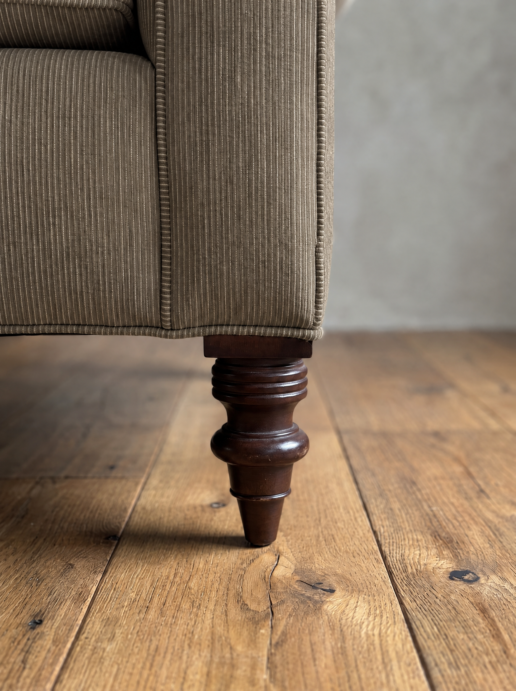Detail of the turned mahogany leg and corner welt