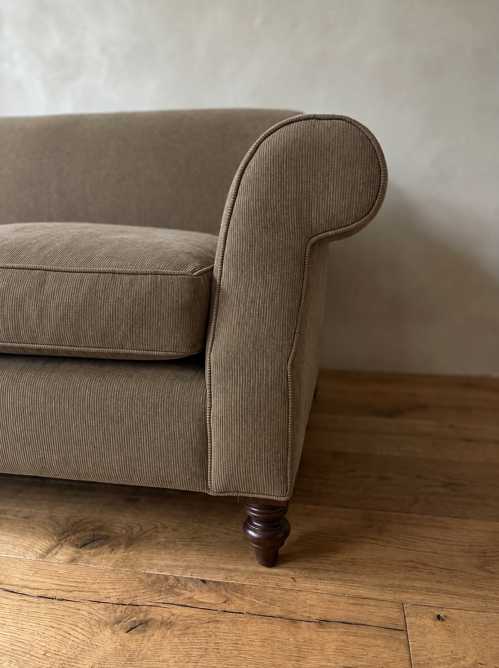 Detail of the scroll arm and fine pinstripe fabric