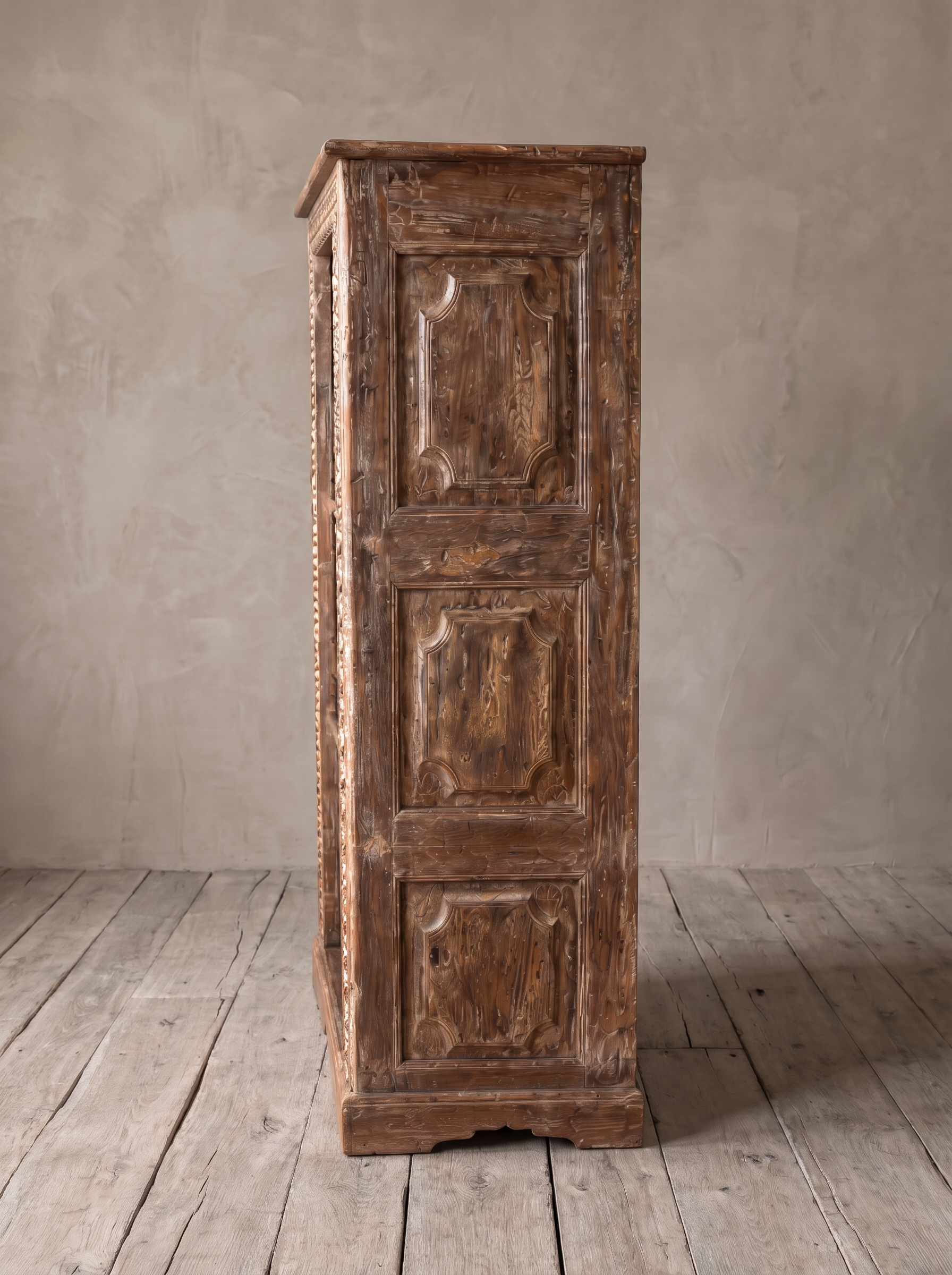 Side of the bookcase with three raised carved panels and a shaped plinth.