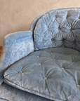 Close-up of the button-tufted velvet back and seat cushion