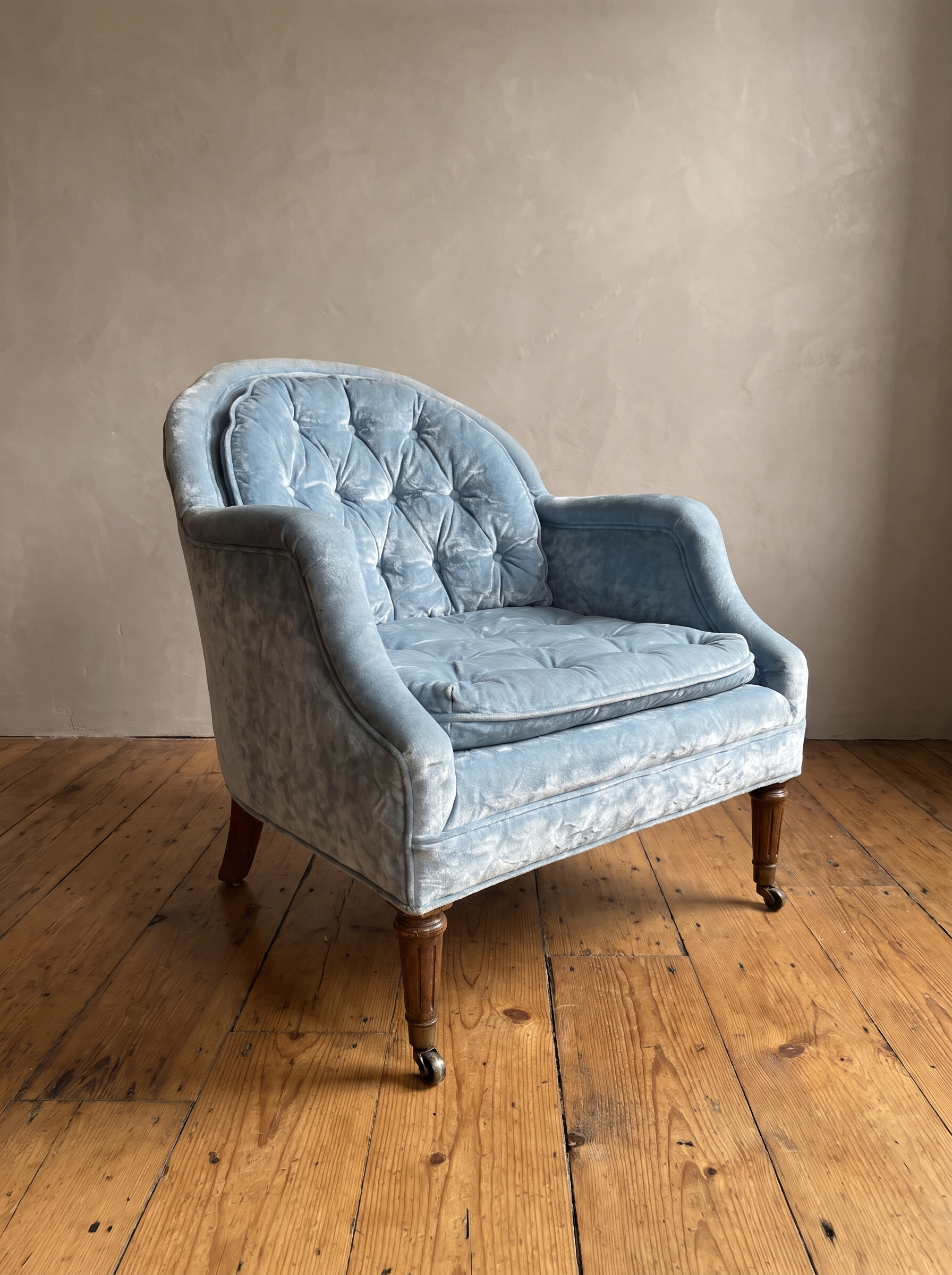 Powder blue velvet tub chair, three-quarter view from the right