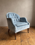 Powder blue velvet tub chair, three-quarter view from the right